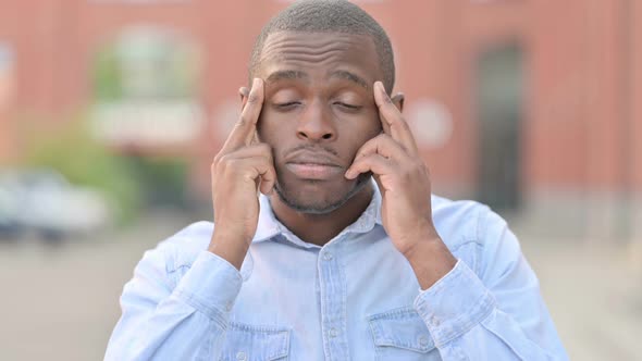 Outdoor Portrait of Tired Young African Man Having Headache