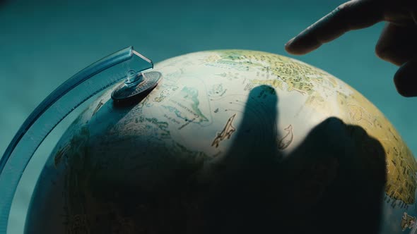 Close Up of Finger Pointing on Globe