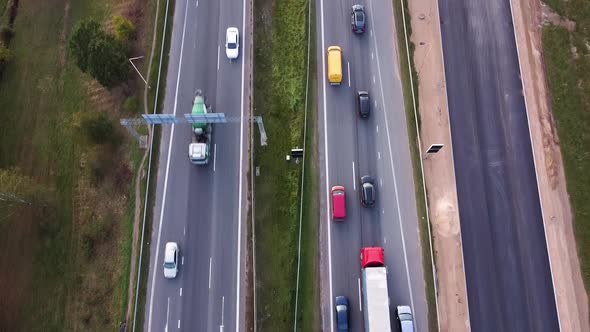 Directly above shot of the A1 highway (freeway) in Kaunas city while the drone is flying forwards an