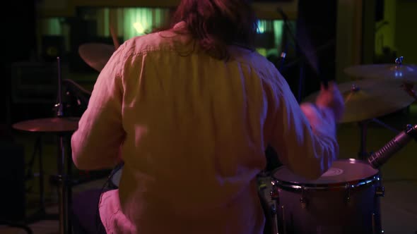 Man playing drums in a music studio