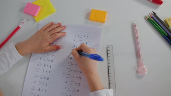Primary School Girl Doing Mathematics Homework Lesson Close Up Written
