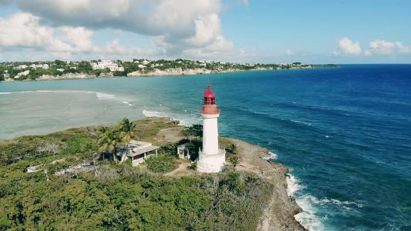 White Lighthouse on Island Near Sea.