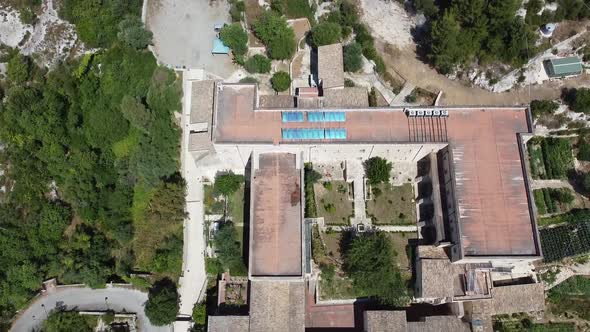 Flying Over The Santuario Santa Maria Scala del Paradiso Surrounded By Green Trees Near The Old City