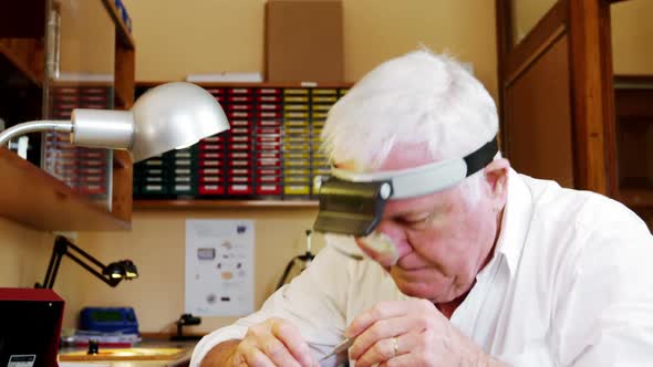 Horologist repairing a watch