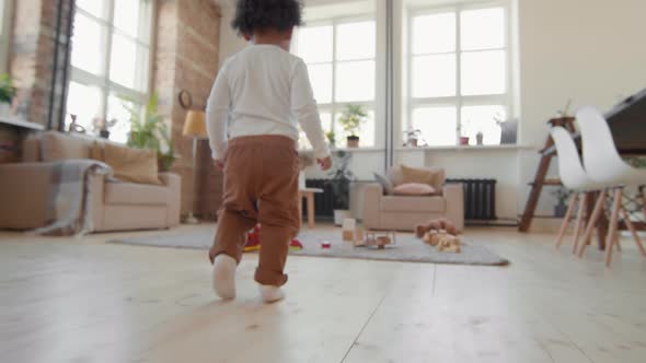 Toddler Boy Walking in Living Room