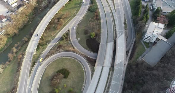 Aerial view of highway multi level junction road with moving cars.