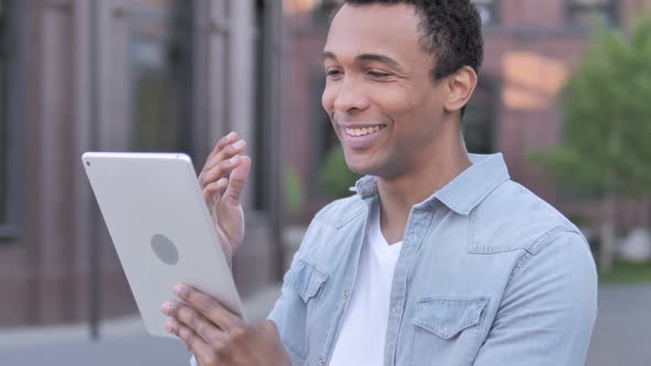 Outdoor Video Chat on Tablet By African Man