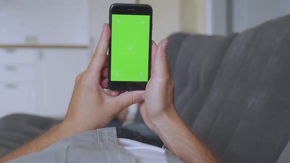 Man Using Smartphone with Green Screen