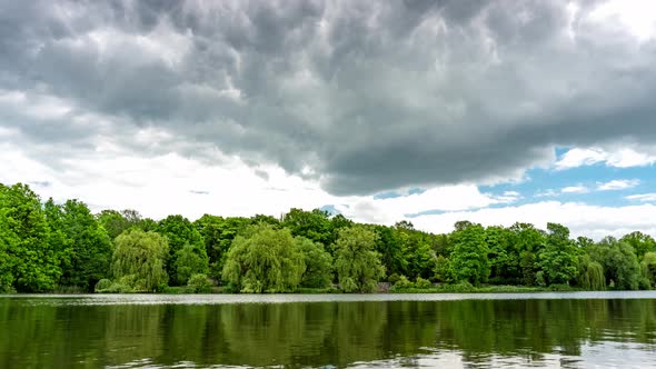 Calm lake in green city park.