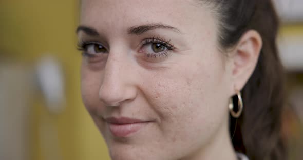 Portrait of young woman at home smiling and looking at camera