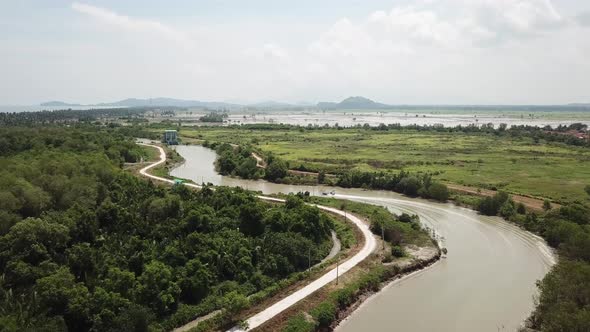 Aerial fly follow boat back to home follow narrow river