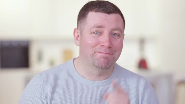 Portrait of Cheerful Positive Caucasian Man Talking Pointing at Camera and Showing Thumbs Up
