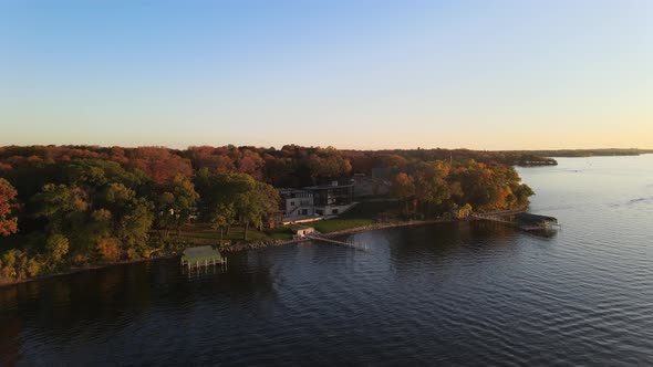 Luxurious property by the lake front facing a gorgeous sunset during a autumn afternoon