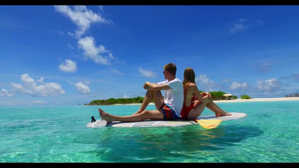 Romantic couple sunbathe on marine sea view beach lifestyle by blue sea with white sand background o