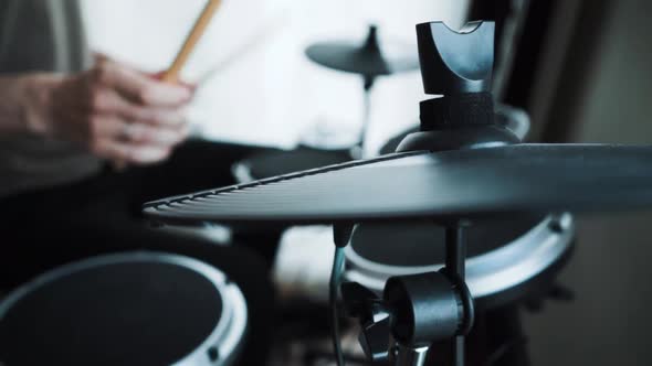 Young Male Drummer Playing Electronic Drum Kit at Home. Rock Music Performance. Percussion