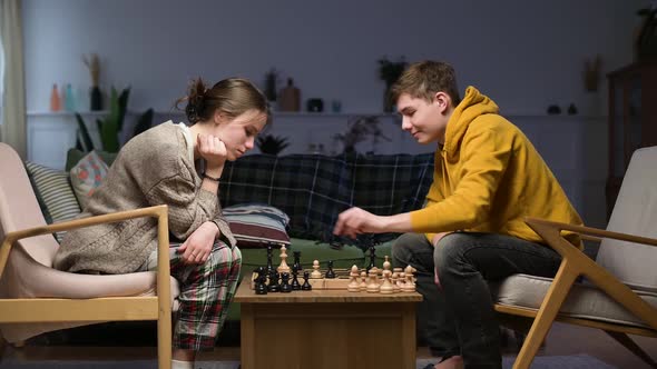 A young man wins a game of chess from his girlfriend by checkmating her