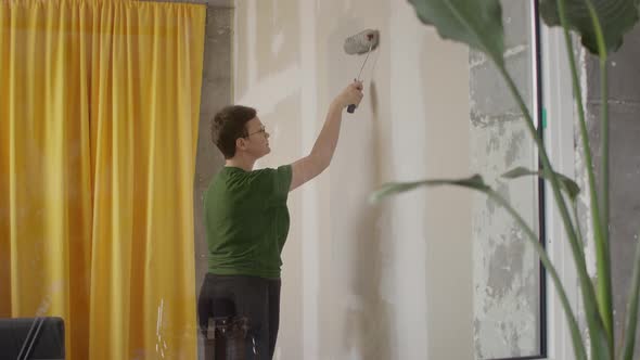 Woman Paint Wall in Her Room in Grey DIY Home Repair