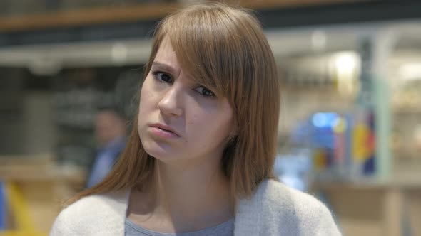 Portrait of Young Woman in Anger, Yelling in Cafe