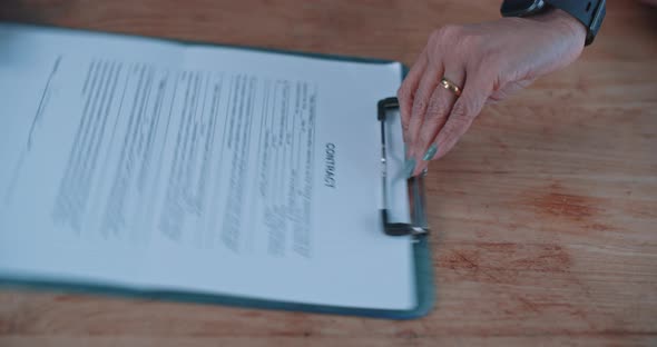 Close up of a busineswoman handing over a contract to a businessman