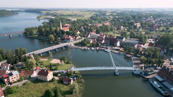 Mikolajki, Poland - An drone round flight aerial bird view starting at the pedestrian bridge most wi