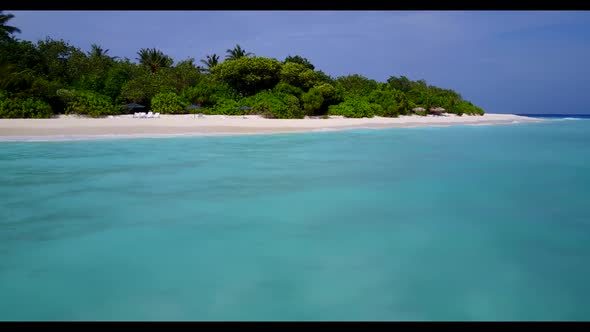 Aerial drone shot scenery of marine seashore beach lifestyle by blue sea and white sandy background 