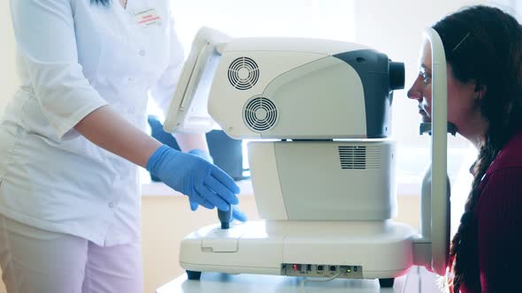 Specialist is Using a Medical Complex to Examine Lady's Eyes