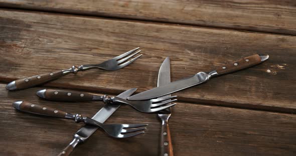 Various cutlery on wooden table 4k