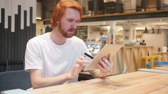 Online Shopping on Tablet PC By Man in Cafe Credit Card