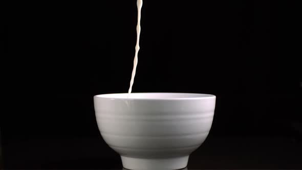 Milk pouring in a bowl