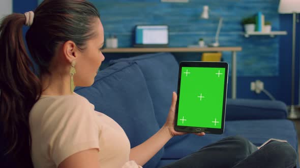Freelancer Woman Looking at Green Mock Up Screen Tablet Computer