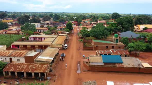 Drone flying low over an African village market.
