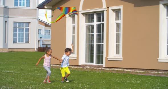 Children Flying Colorful Kite alt