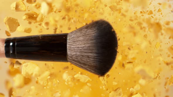 Super Slow Motion Shot of Makeup Brush and Golden Powder Explosion at 1000 Fps