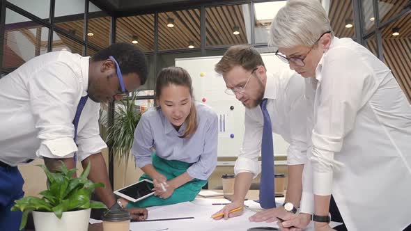 Casual Office, Multiracial Architects Working on Project Blueprint