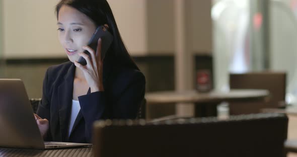 Businesswoman working on laptop computer at night