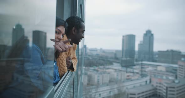 Couple looking out of window of a property on a viewing