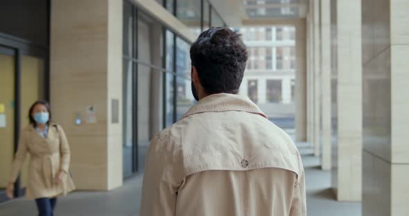 Back View of Man Waiting Wife From Work Outdoors in City