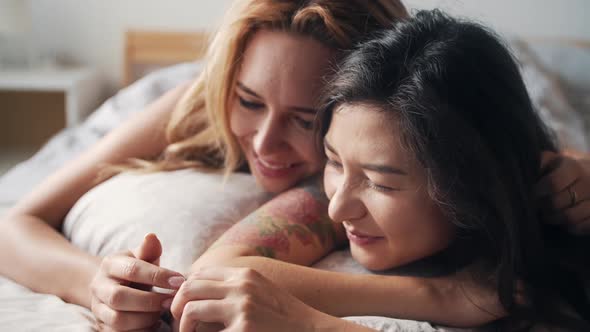 Homosexual Lesbian Couple Lying in Bed Together