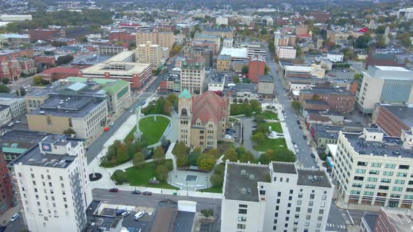 An aerial fly-over PA, Pennsylvania downtown on a summer morning focusing on church in the middle.