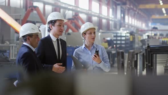 Group of Supervisors Inspecting Factory Workshop