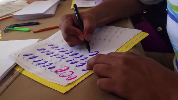 Man doing Circles in Calligraphy Practice Course