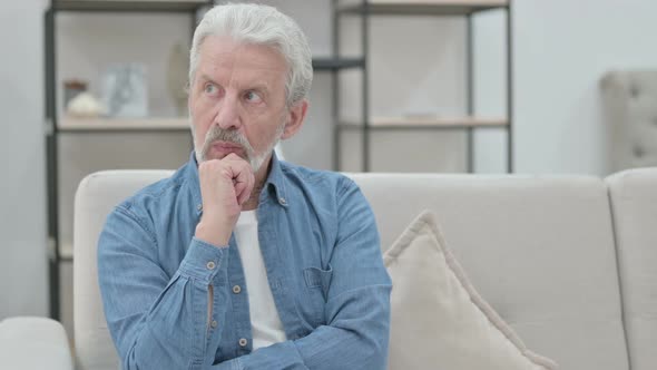 Old Man Thinking While Sitting on Sofa