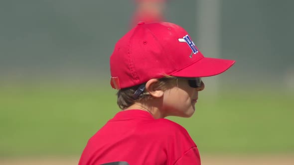 Kids playing little league baseball.