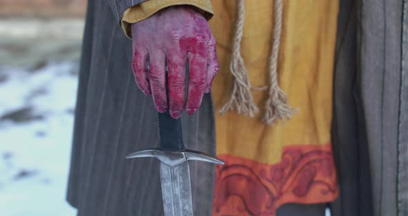 View of Wounded Hand with Blood Leaned on a Sword