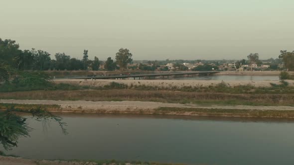 Aerial Over Waterway With Bridge In Background In Karachi, Pakistan. Dolly Forward