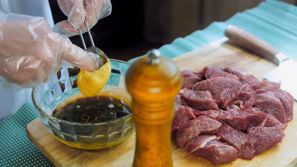 The Chef Adds a Tablespoon of Dijon Mustard to the Bowl with the Ingredients for the Marinade Sauce