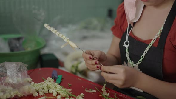 Woman Creatively Making A Thai Flower Garland (Phuang Malai) In Flower MarketPak Khlong Talat