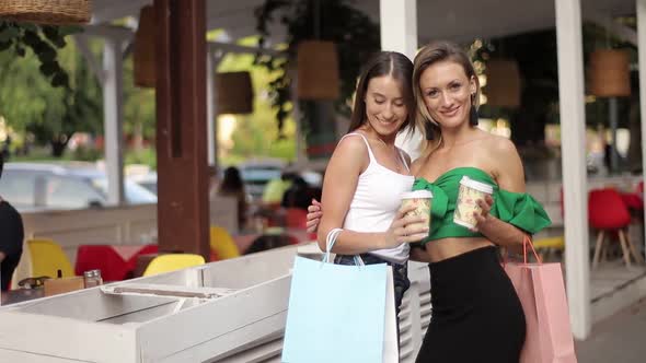 Two Happy Girls Shopping Girl with Shopping Coming From a Shopping Center