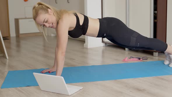 Attractive Sportswoman Doing Push Ups at Home