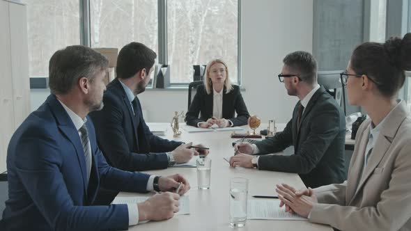 Lawyers Discussing Case at Meeting Table